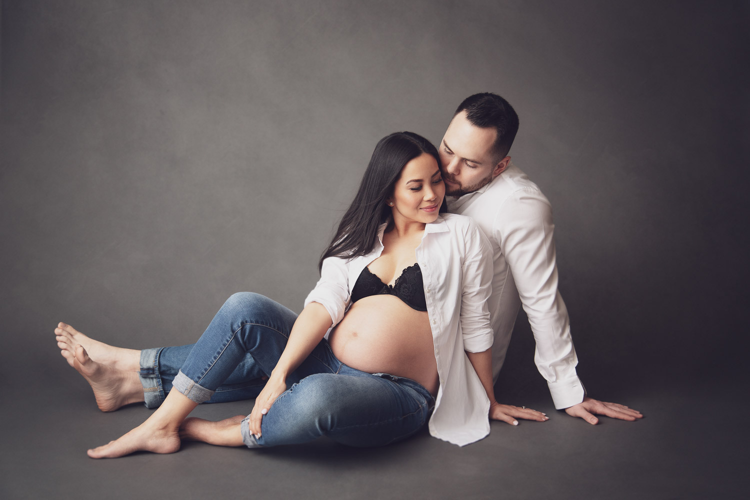 artistic and casual maternity shot with studio lighting and texture background