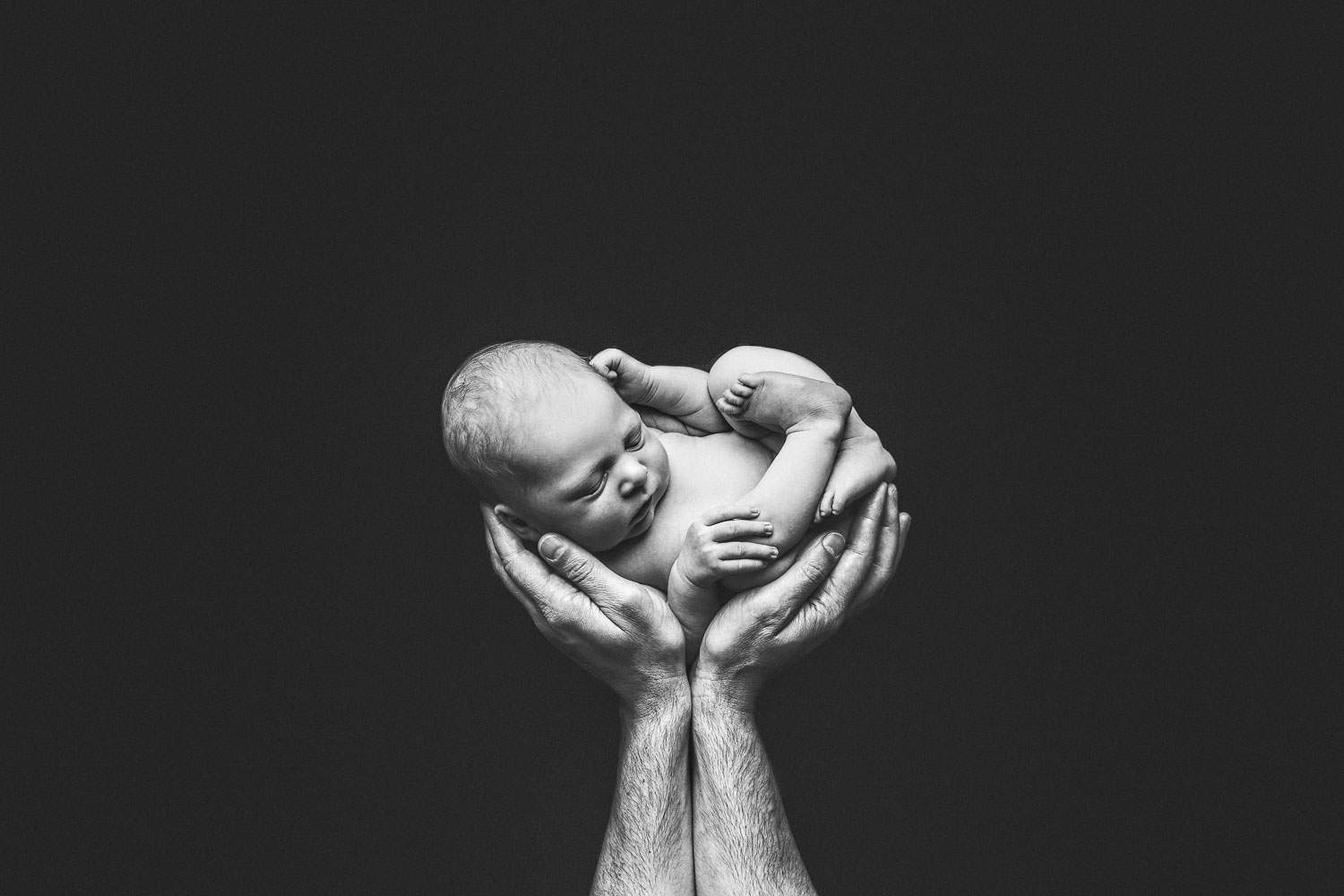 black and white newborn baby boy and dad hand | Jana photography