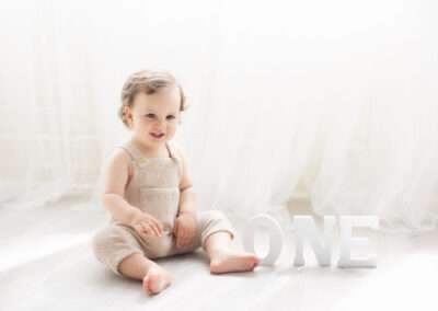 one year old boy in a timeless white background