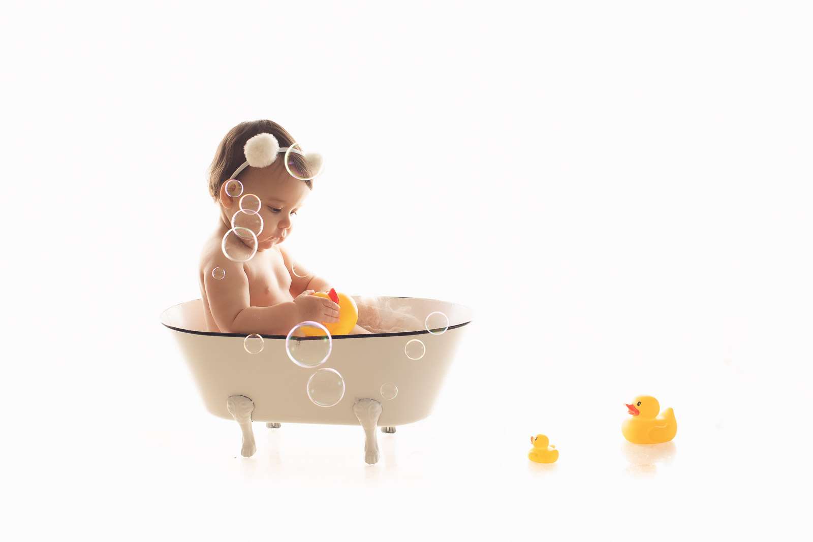 girl in the bubble bath with ducks