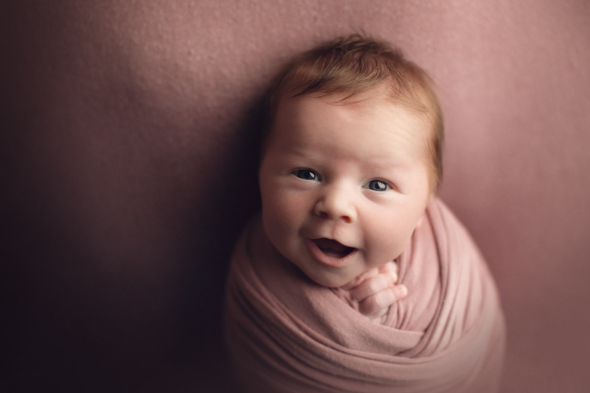 newborn baby girl - open eyes smiles