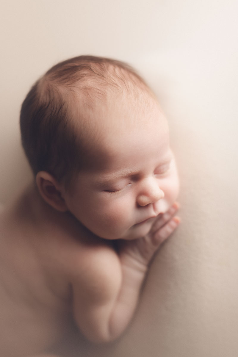 newborn photography girl cream background