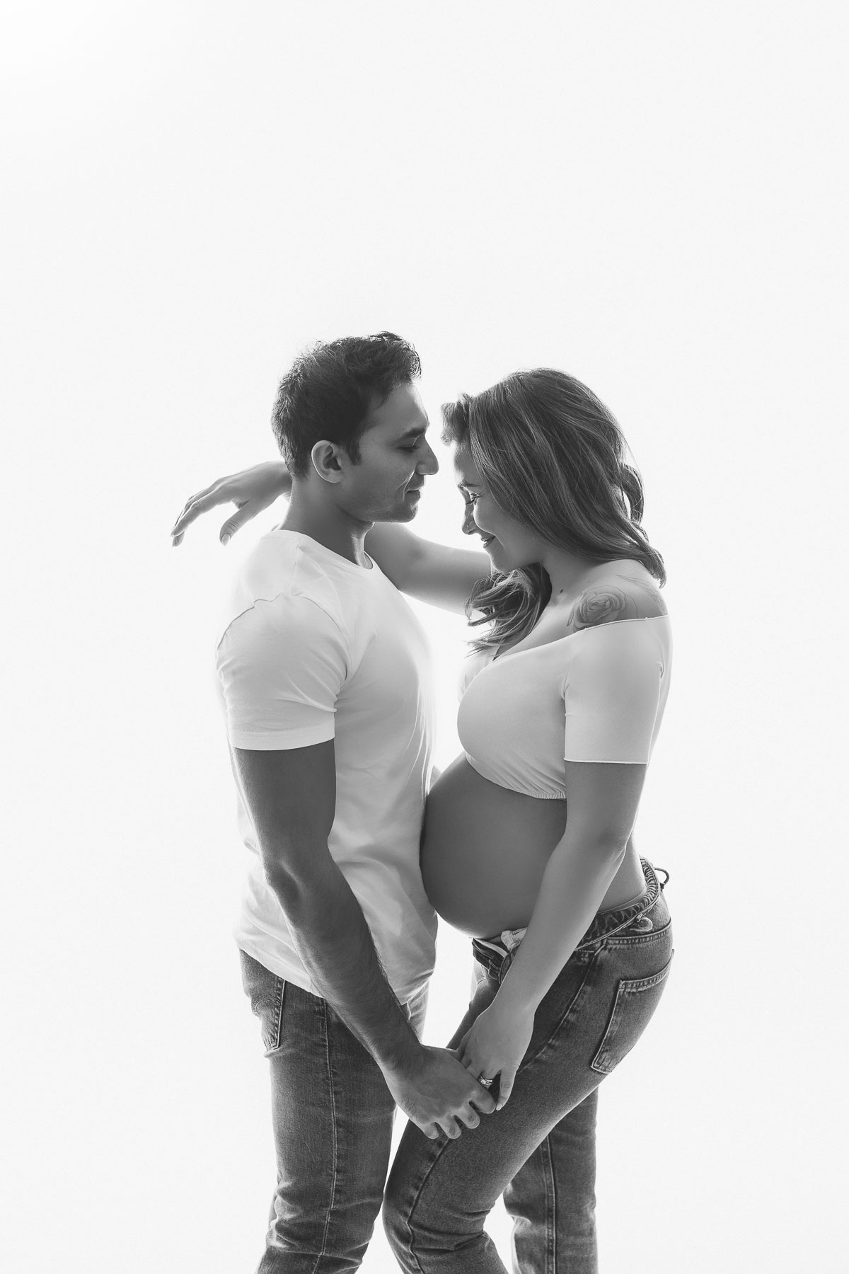couple pregnancy photos with jeans and white tops dreamy and beautiful maternity photography