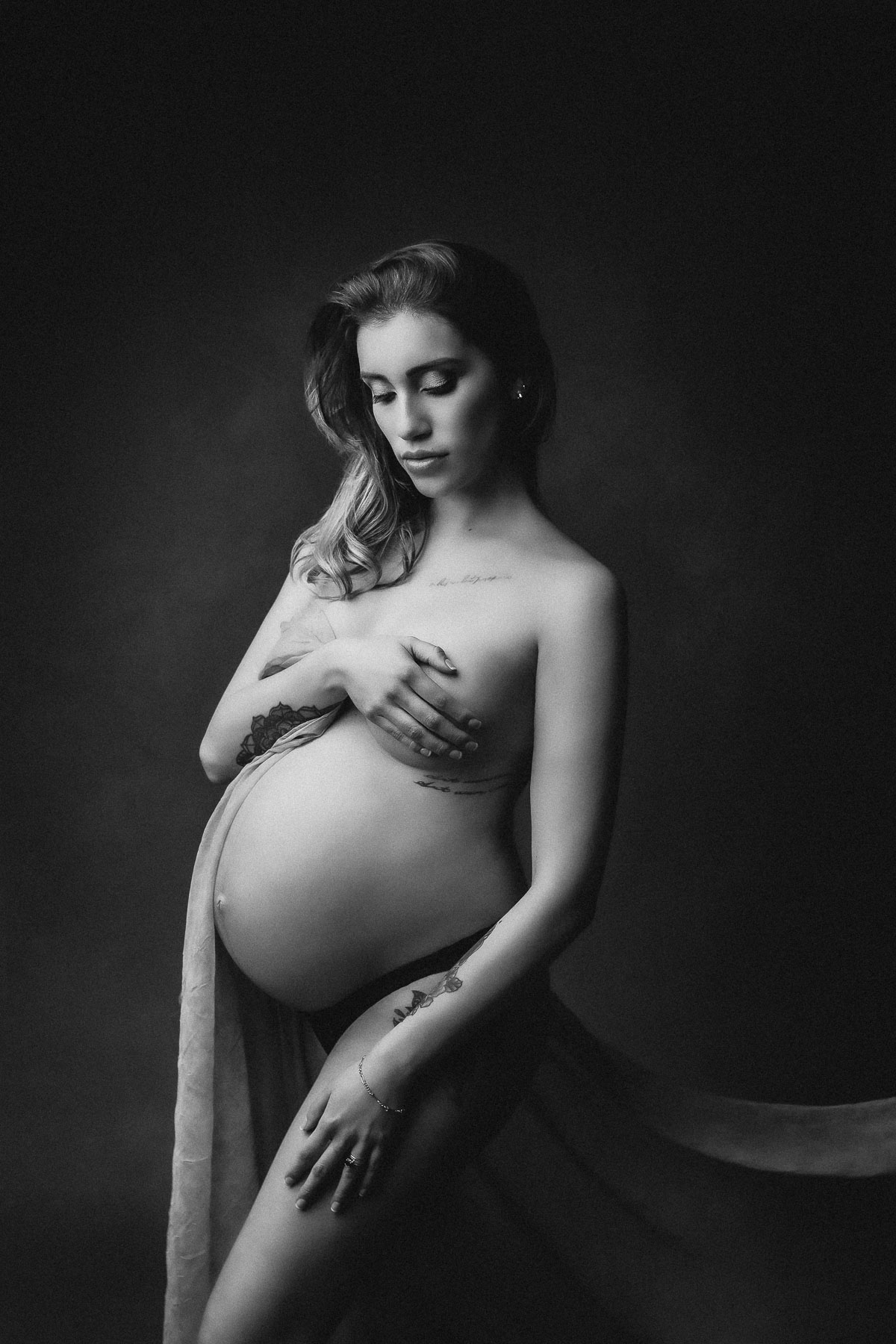 fashion fine art black and white maternity photo with professional studio lighting