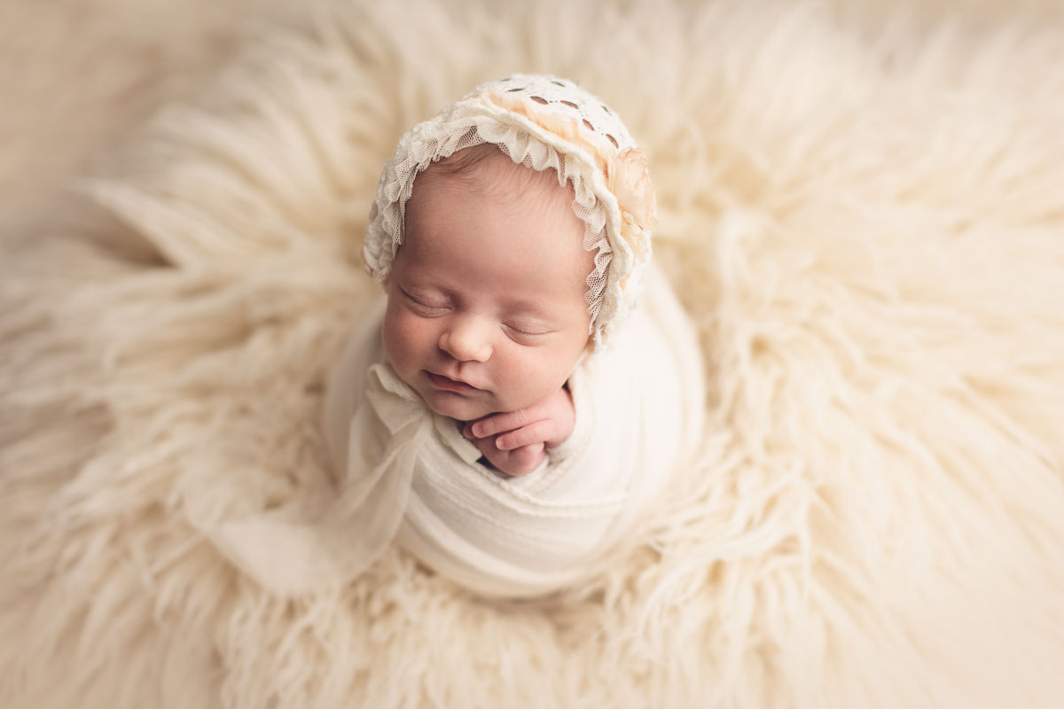Vancouver - Burnaby and surrey - newborn photography - baby girl with white hat in a white flokati