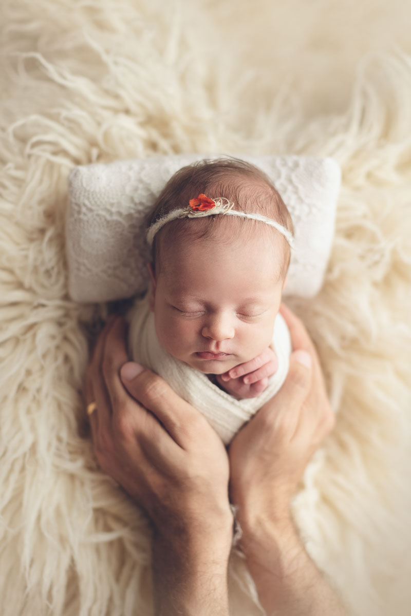 Vancouver - Burnaby and surrey - newborn photography - baby girl with white headband in a white flokati and dad's hand
