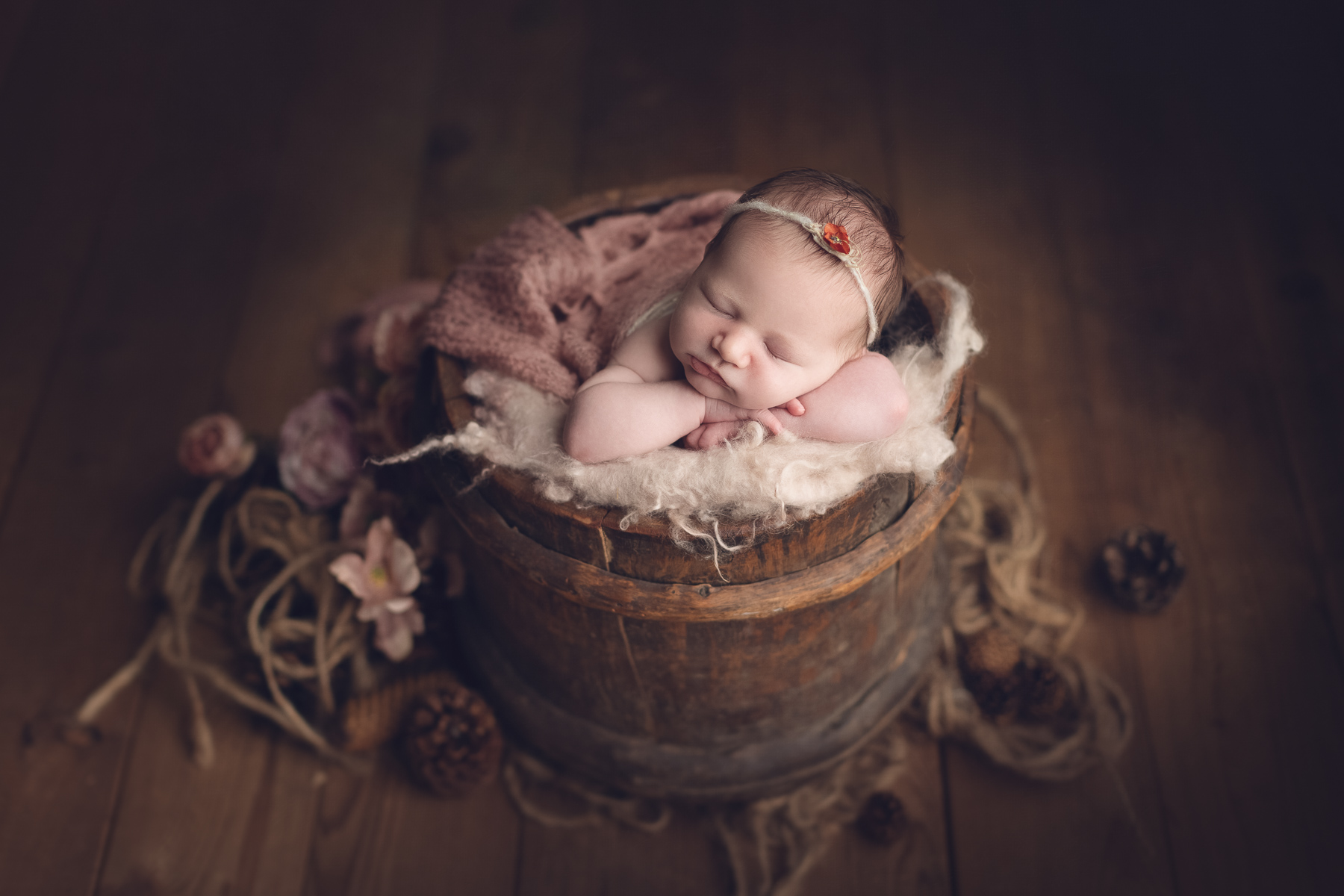 best newborn photographer in burnaby, classic package sample - baby girl sleeping on a brown bucket