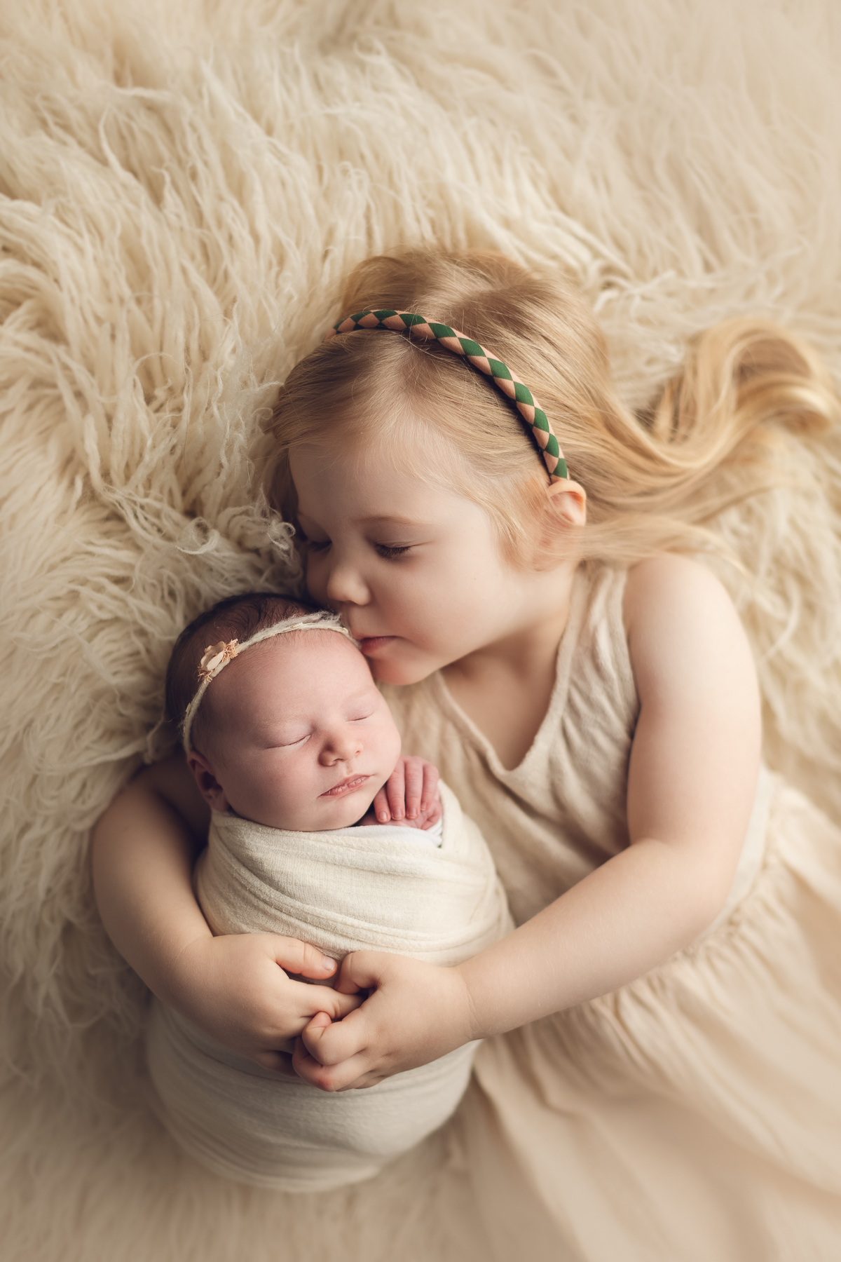 sibling and newborn photography in white color fur. best newborn photographer in surrey